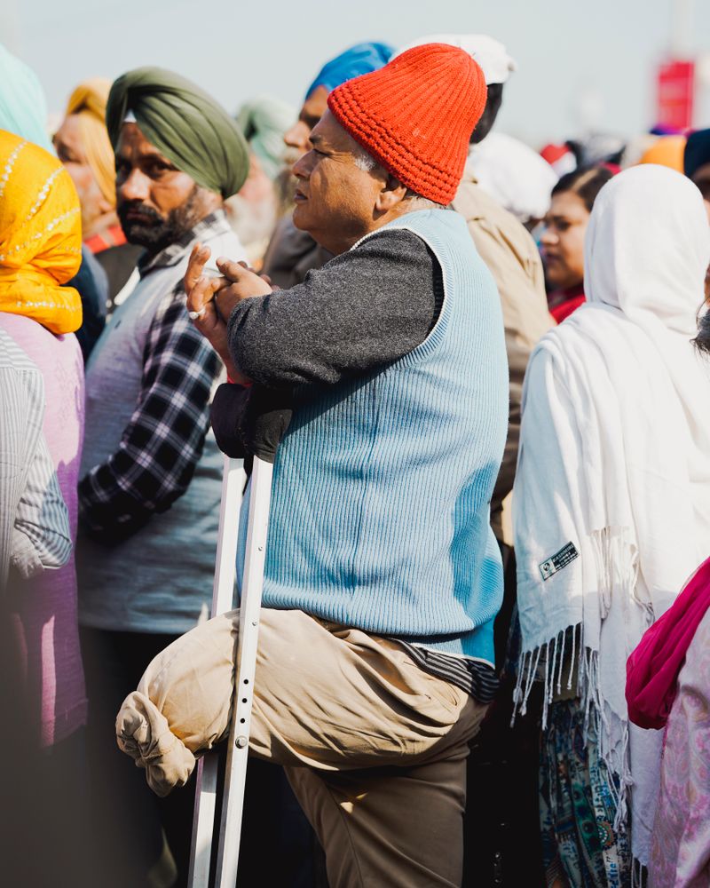 Man using crutches in a crowd in India